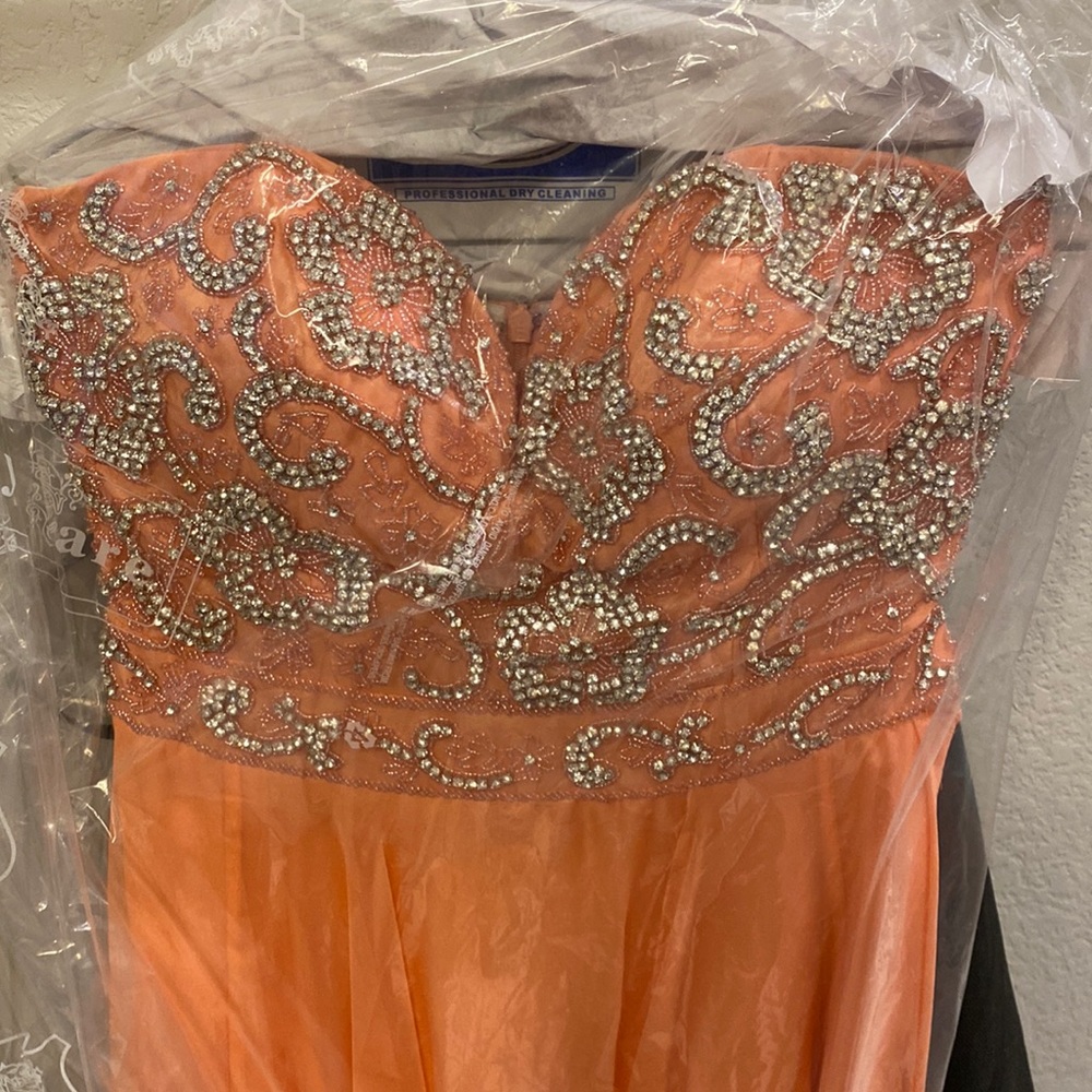 Coral, long, strapless, prom dress with stunning heading at the top